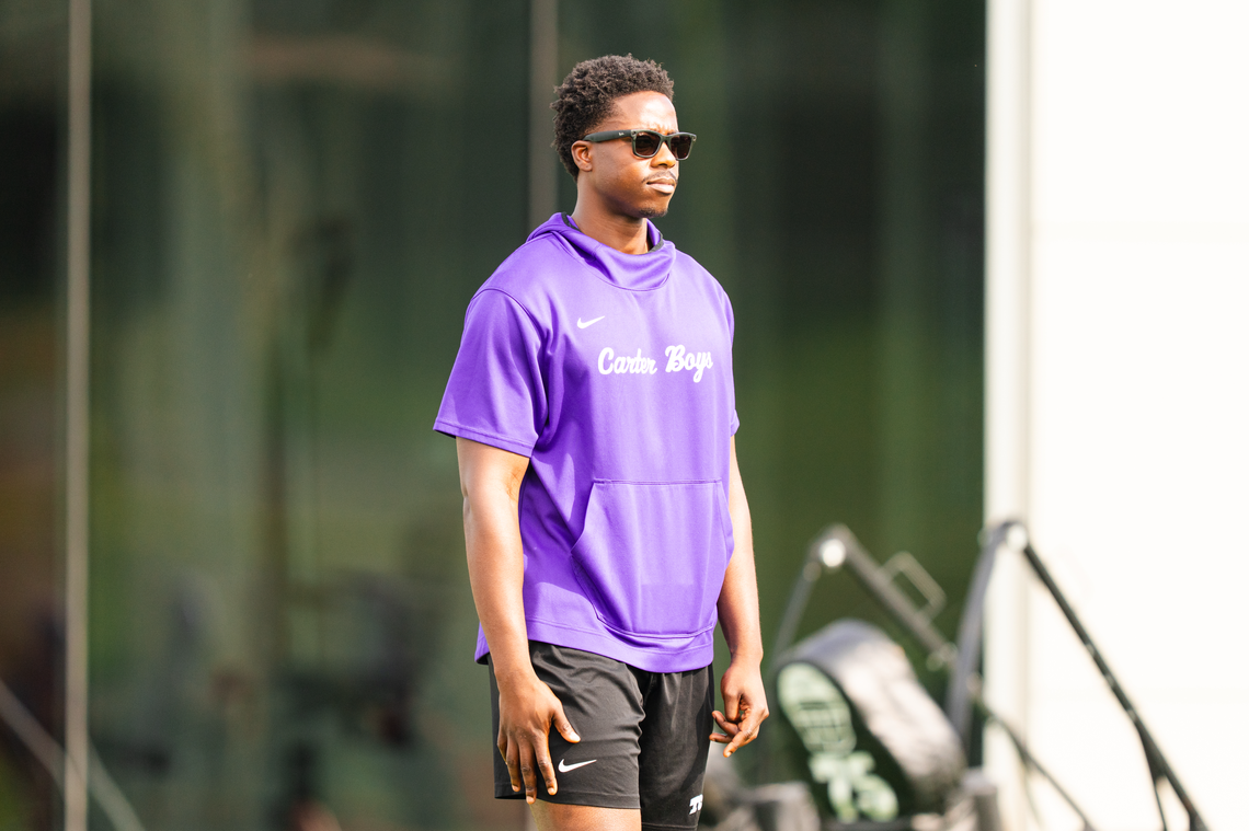 TCU player personnel graduate assistant Micheal Ibukun-Okeyode watches spring practice Thursday. Ibukun-Okeyode suffered a career-ending neck injury last August.